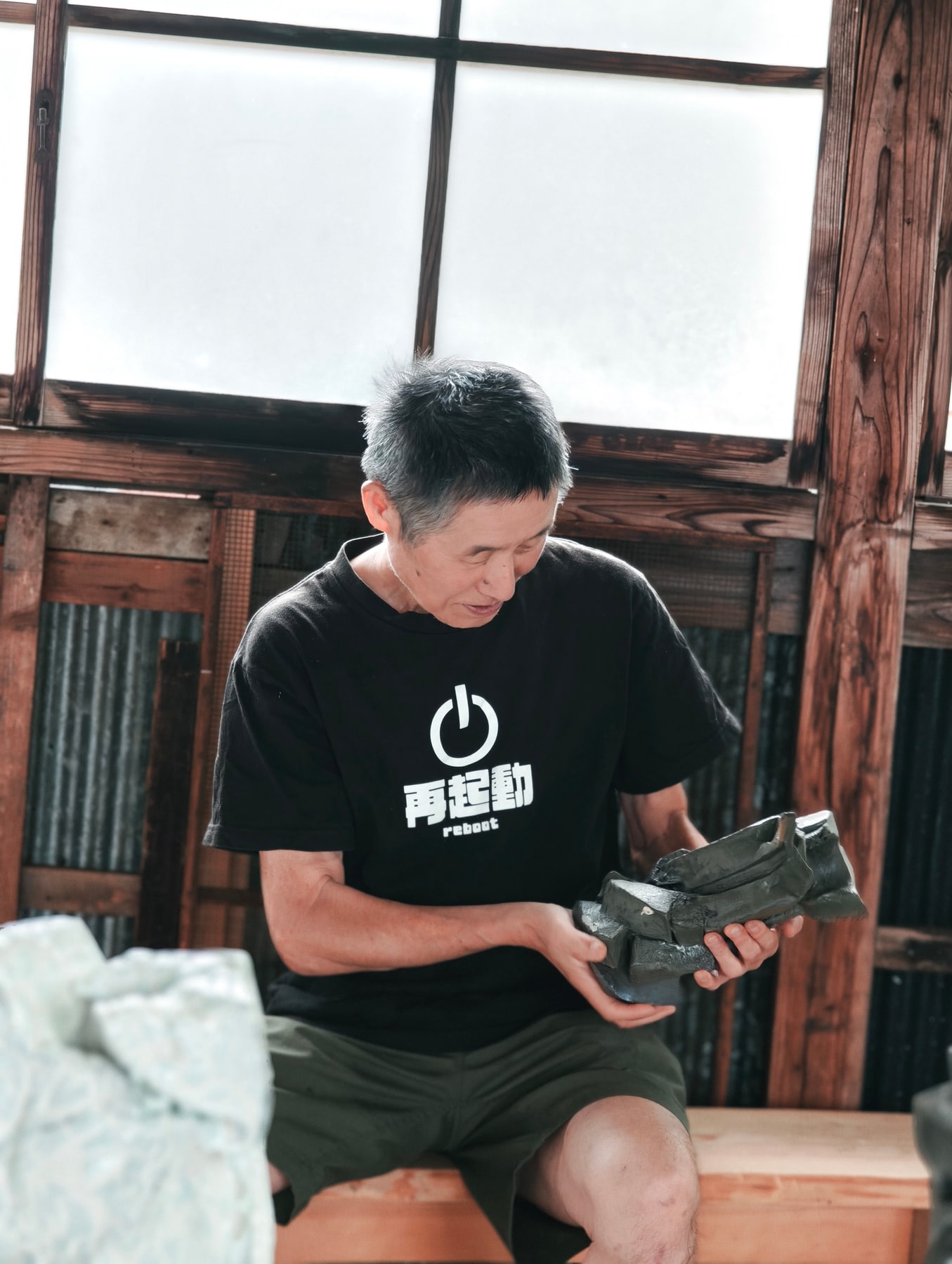 Shozo Michikawa examining a fired ceramic work in the Sasama studio